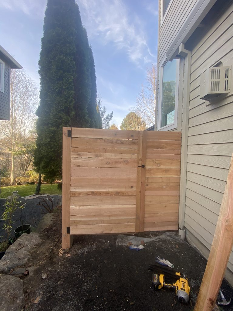 A cedar gate fitted between neighboring homes.