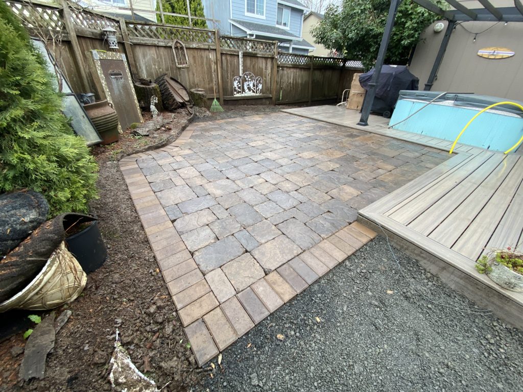 A paved patio adjoining the home and backyard.