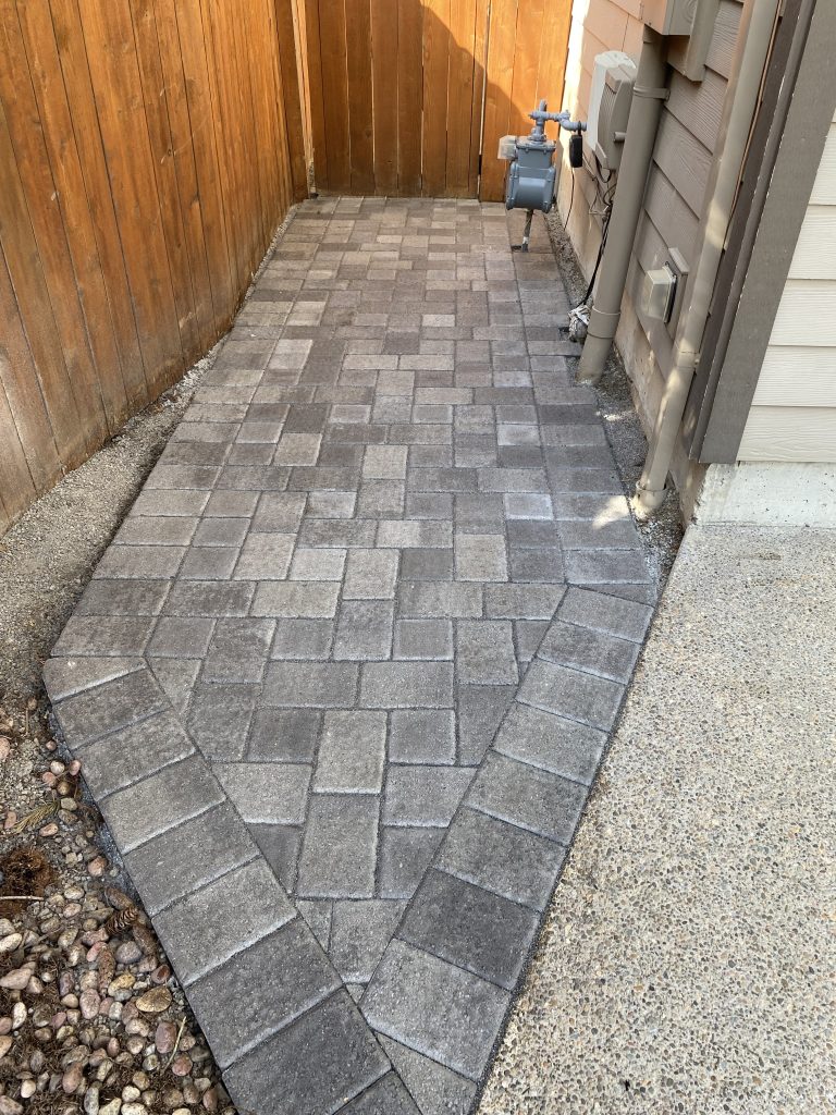 A custom paver walkway along the side of a home.