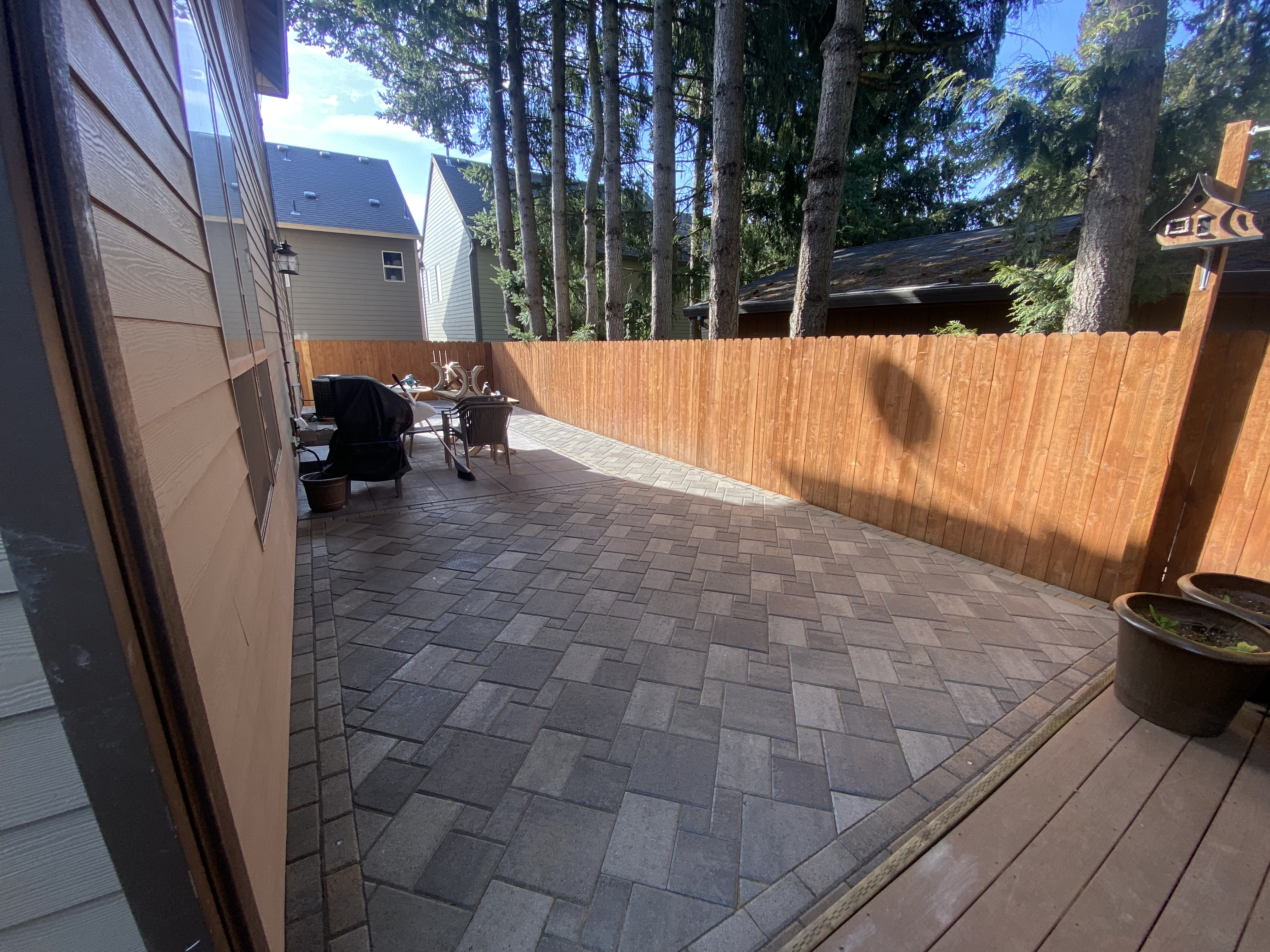 Finished paver courtyard with a cedar privacy fence