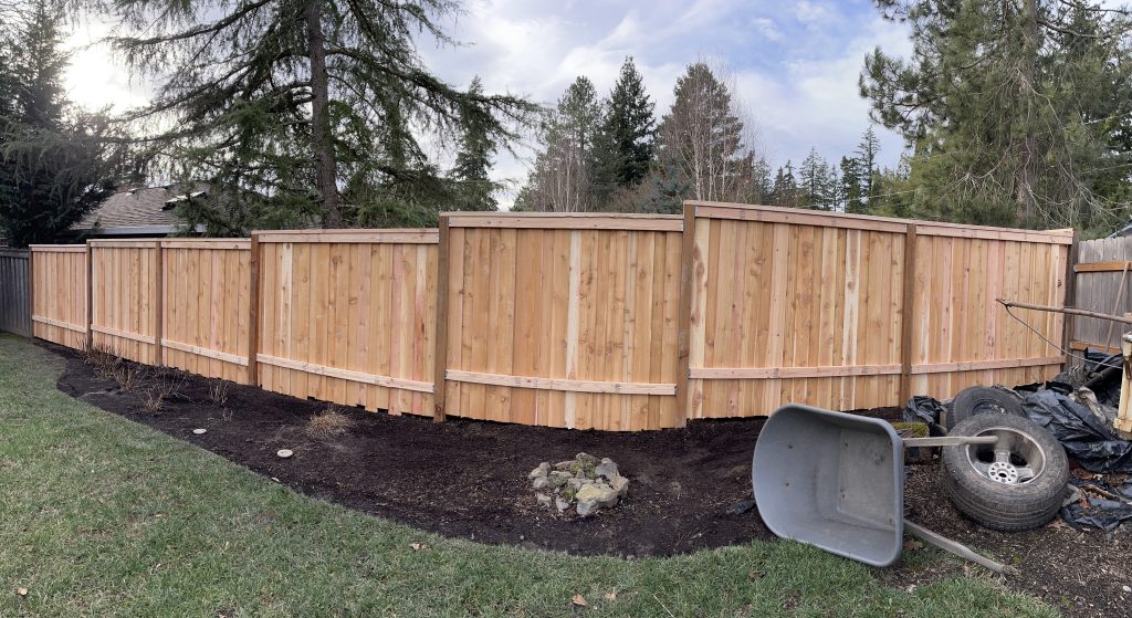 A long cedar fence framing a residential outdoor space.