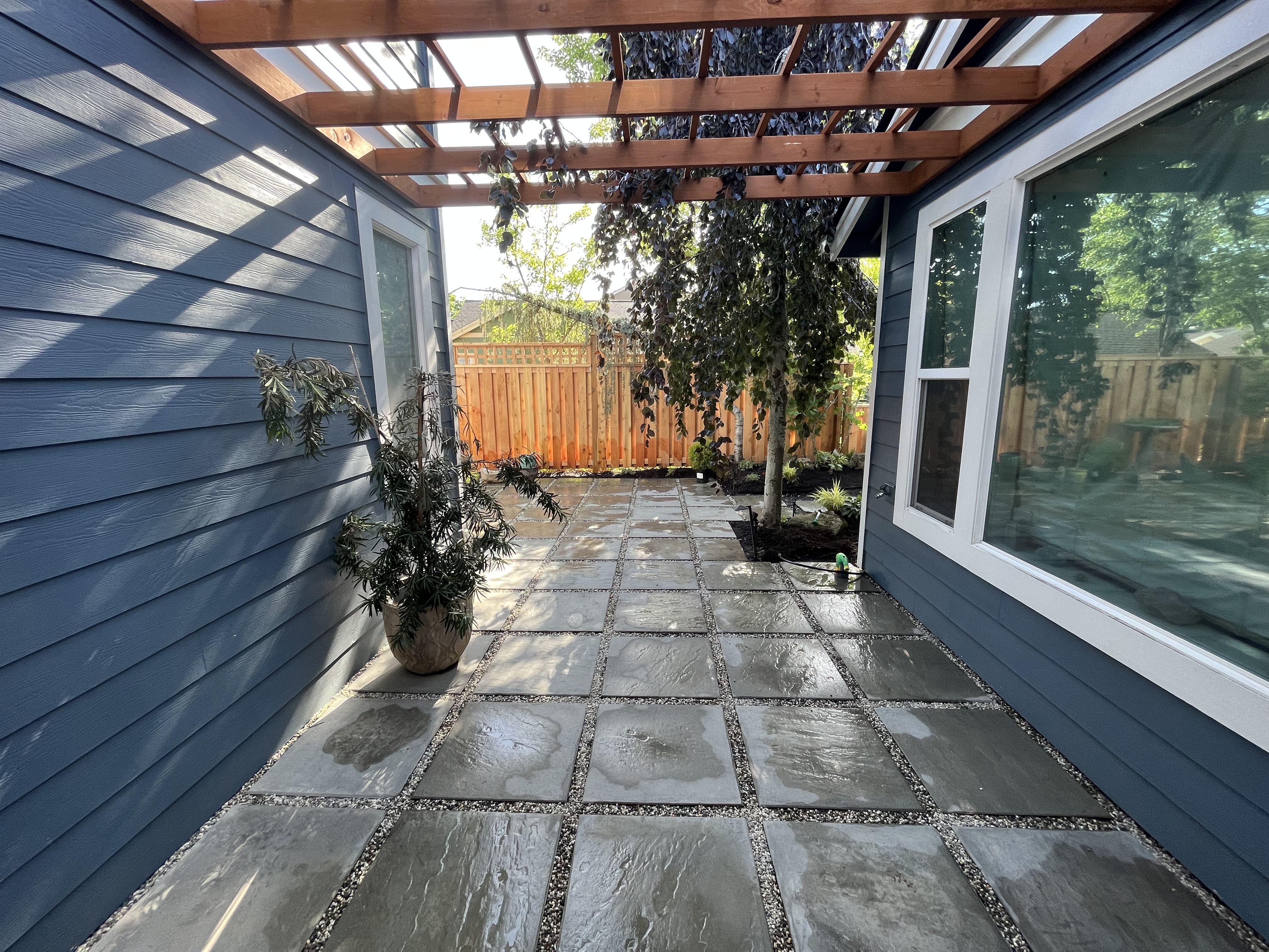 Stone walkway beneath a timber pergola