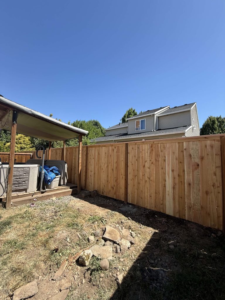 A timber fence and gate at the edge of the yard.