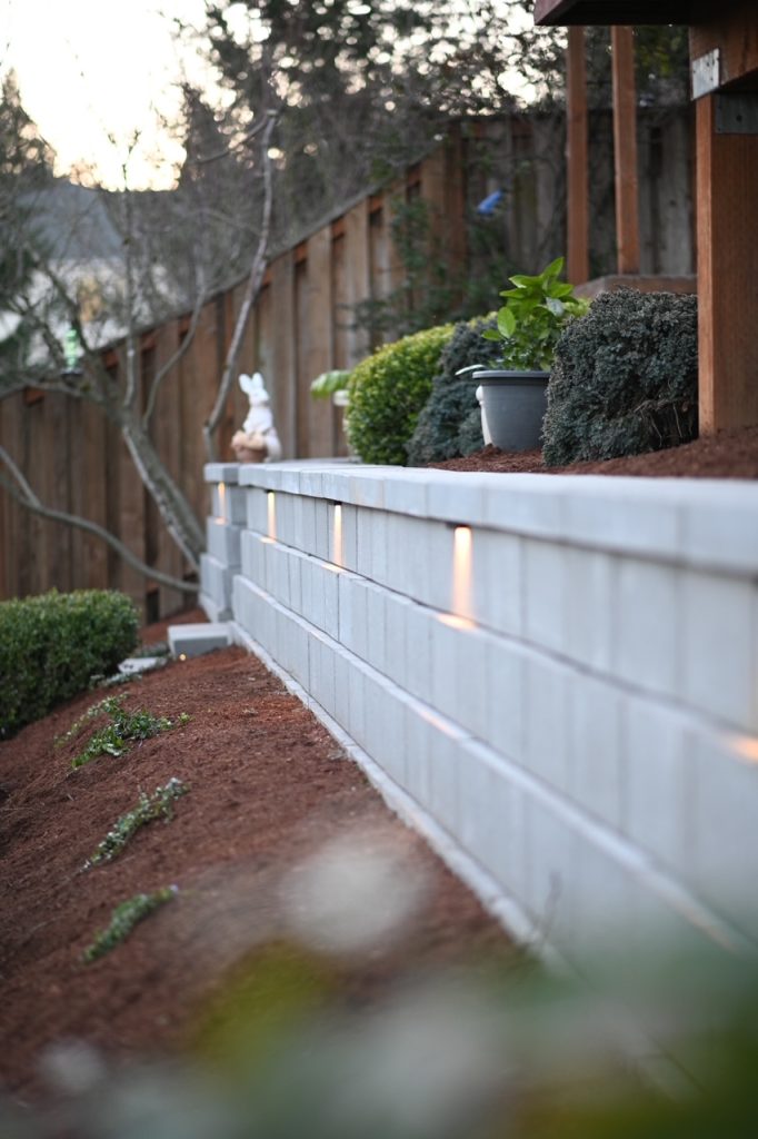 A retaining wall defining a planted garden edge.