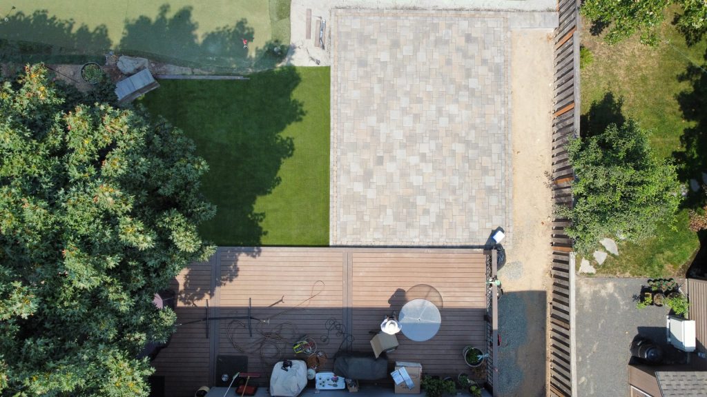 An overhead view of a backyard patio and lawn.