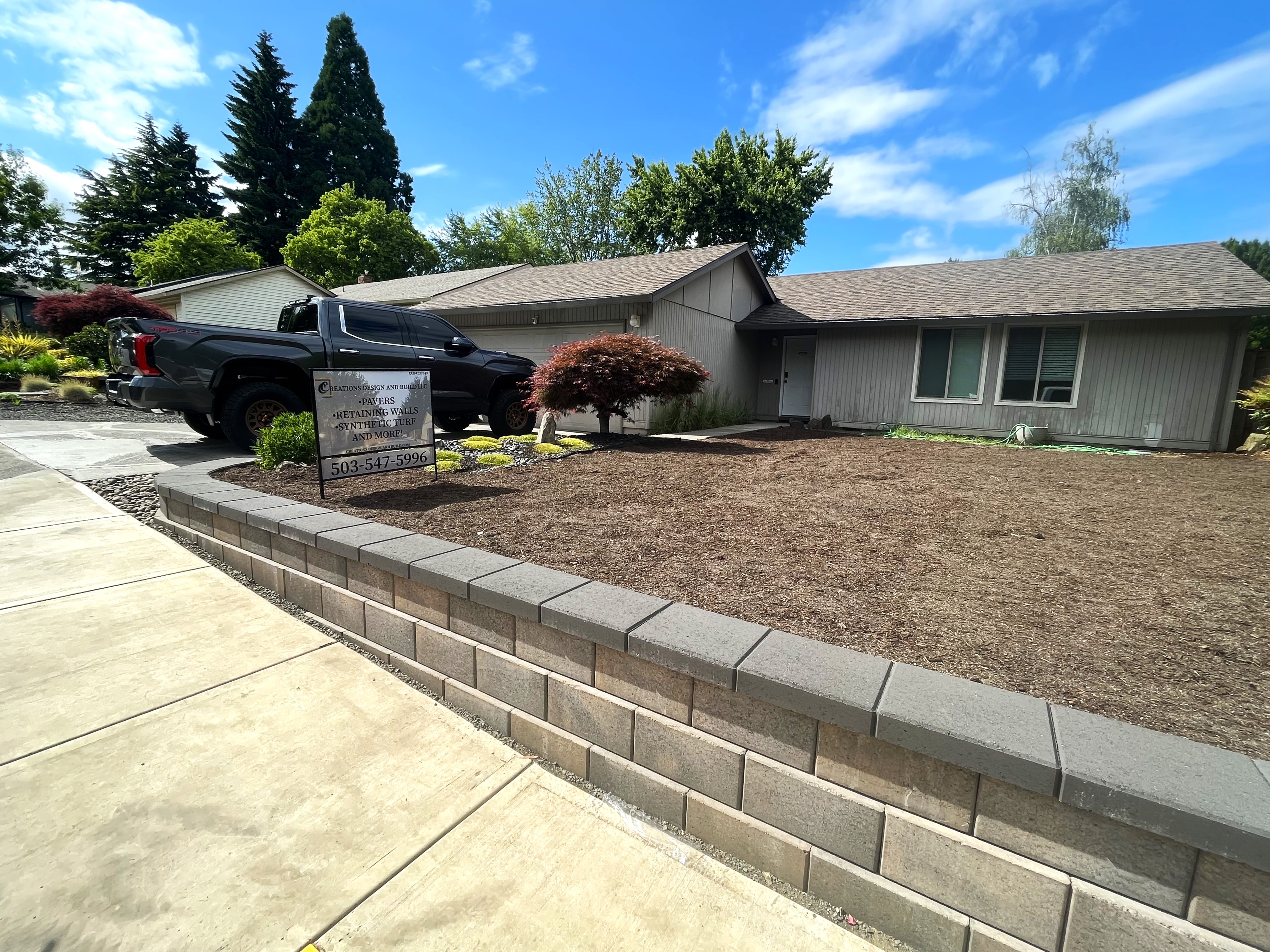 Front yard transformed with retaining walls and hardscaping